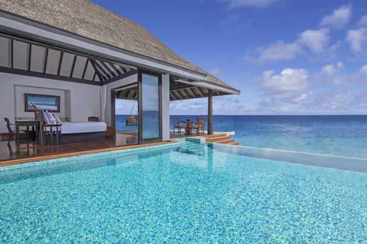 Swimming pool and outdoor deck view of over water pool villa