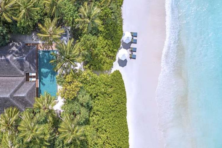 Daylight aerial view of villa, beach and ocean