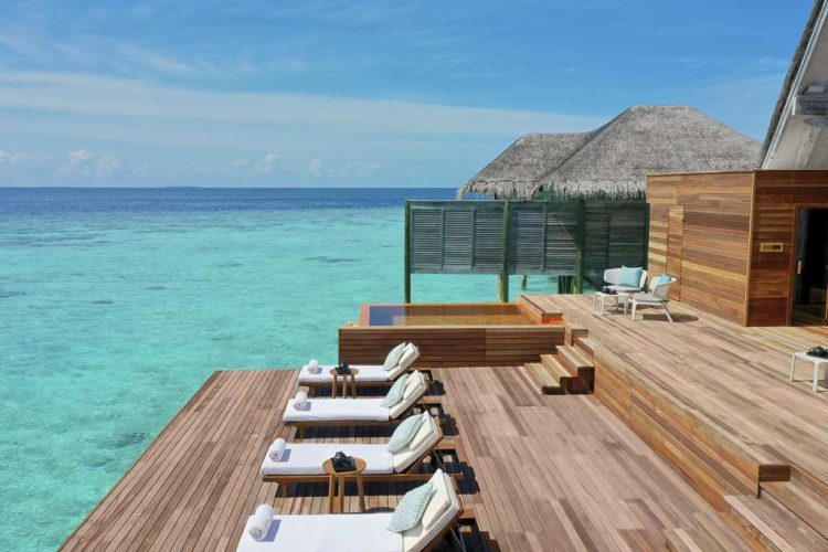 Anantara Kihavah Relaxation Deck with lounge chairs and pool