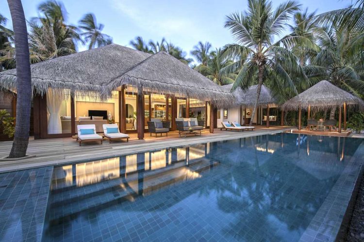 Exterior view of swimming pool and outdoor terrace with sun-loungers, Thai sala and swings of Three