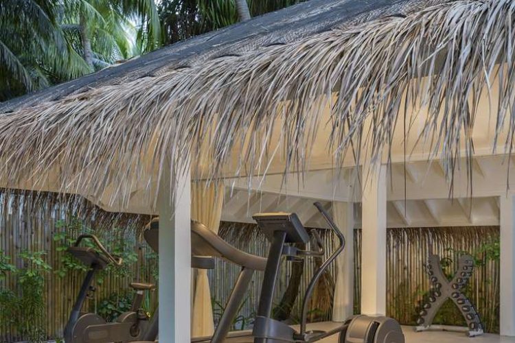 Exterior view of open-air workout pavilion with gym equipment at Three Bedroom Beach Pool Residence