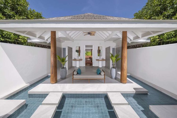 Exterior view of outdoor bathroom in Beach Pool Residence with water feature