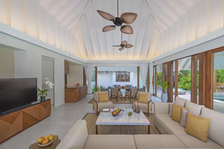 Interior view of lounge and dining area in Two Bedroom Beach Pool Residence with view to terrace and