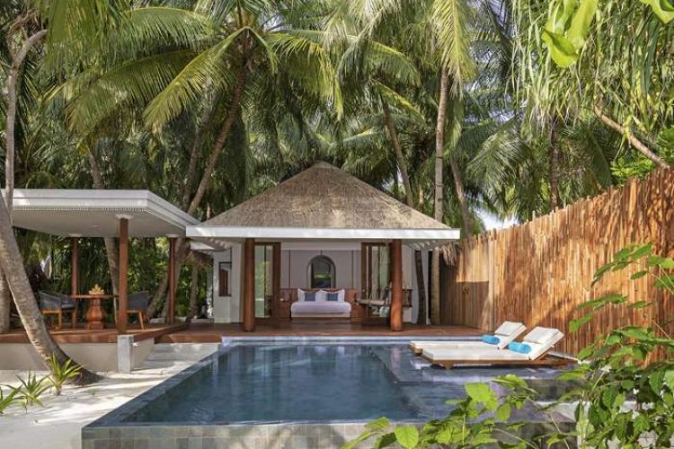 Exterior view of Four Bedroom Beach Pool Residence over swimming pool with sun-loungers and outdoor