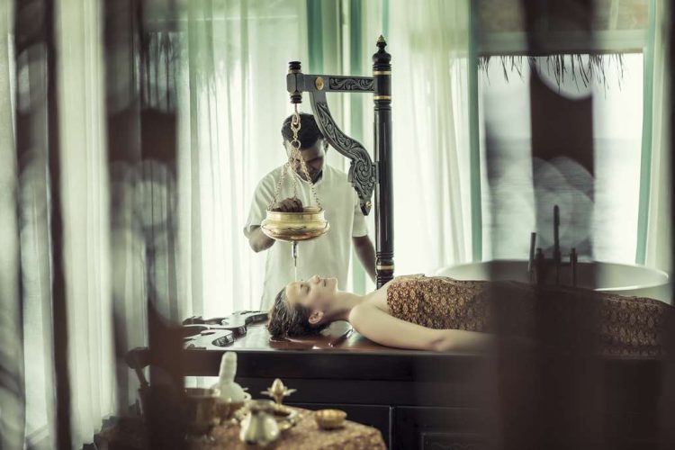 Guest having an Ayurvedic Shirodhara Spa Treatment